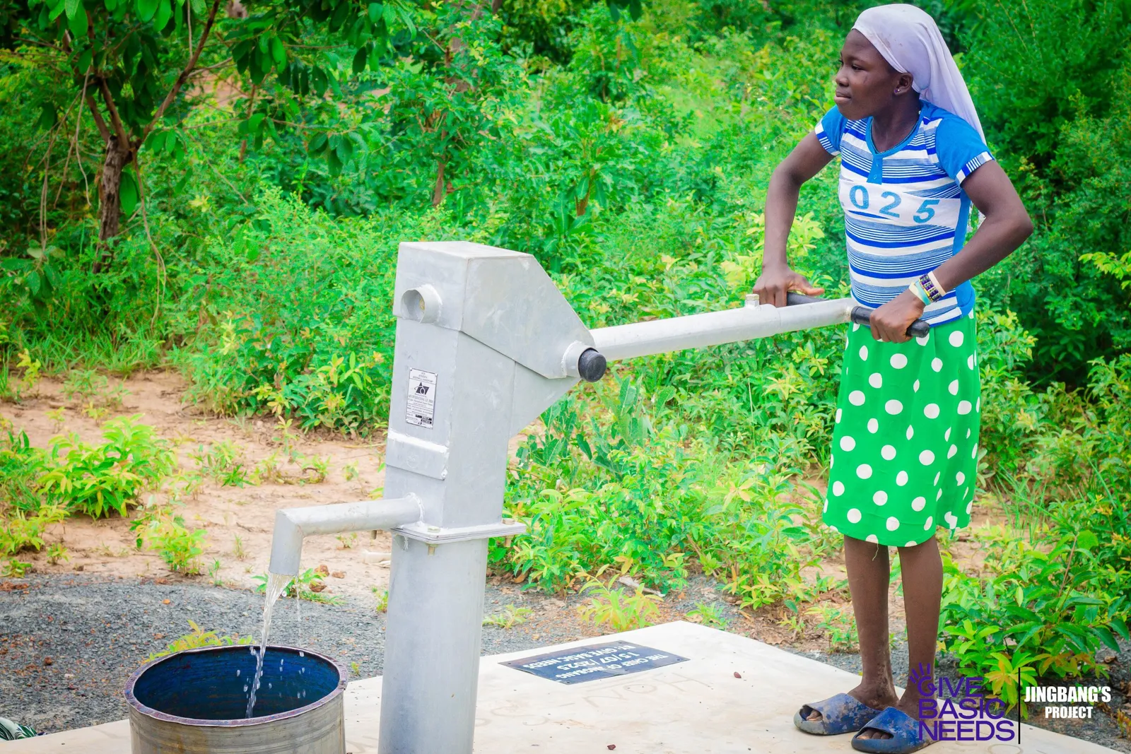 A young girl pumping clean water from a Give Basic Needs borehole in Northern Ghana